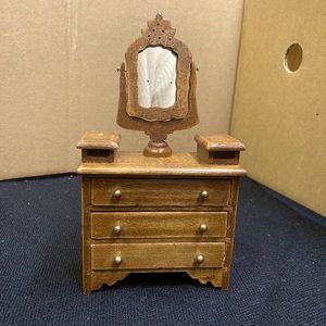 Vintage wooden dollhouse miniature vanity chest of drawers with tilting mirror.